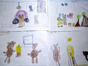Disegni dei bambini di un animale grande e uno piccolo seduti su una poltrona colorata